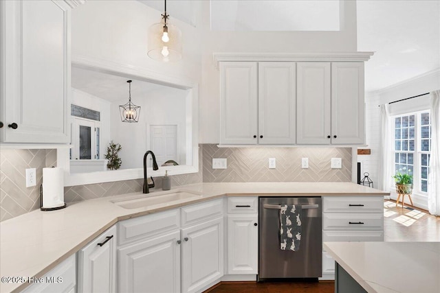 kitchen featuring a sink, dishwasher, and white cabinetry