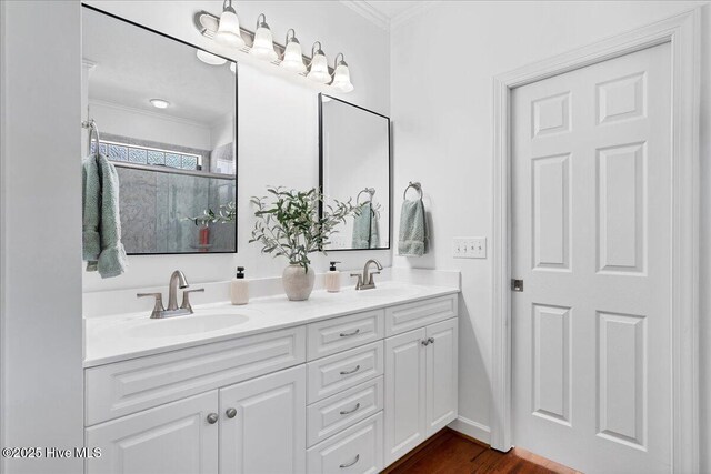 full bath with crown molding, double vanity, and a sink