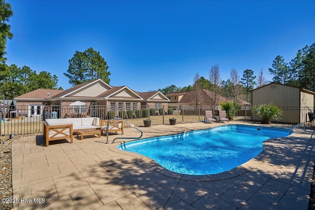 community pool featuring a storage shed, a patio area, fence, and an outdoor structure