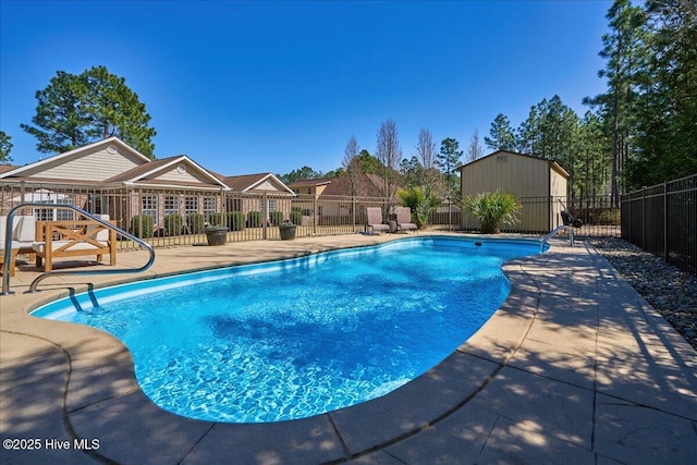 view of pool with a patio area, a fenced in pool, an outdoor structure, and fence