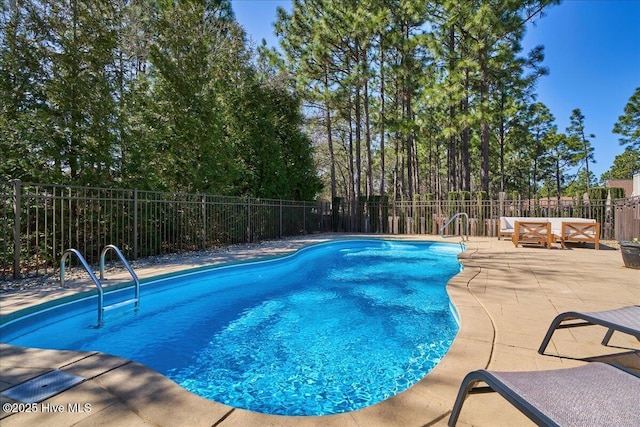 view of pool with a patio area, a fenced in pool, and fence