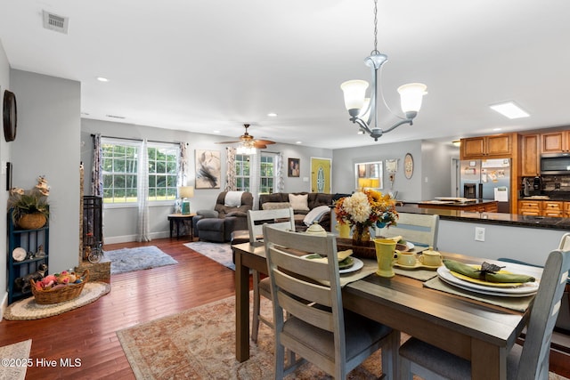 dining area featuring recessed lighting, visible vents, baseboards, wood-type flooring, and ceiling fan with notable chandelier