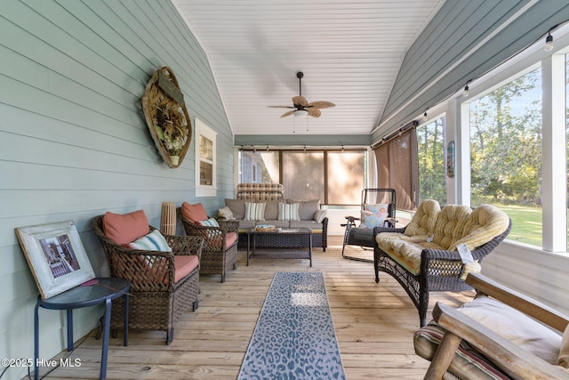 sunroom with vaulted ceiling, plenty of natural light, and ceiling fan