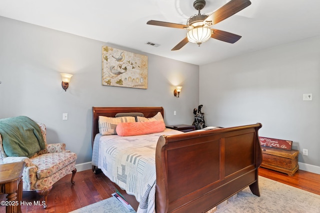 bedroom with baseboards, visible vents, ceiling fan, and wood finished floors