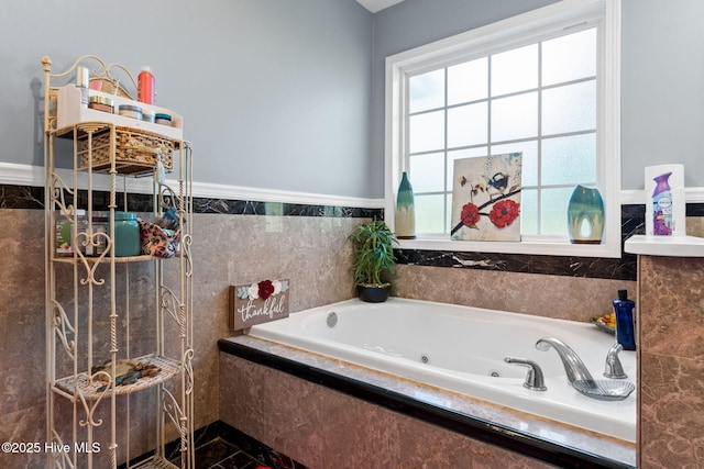 bathroom featuring a healthy amount of sunlight and a jetted tub