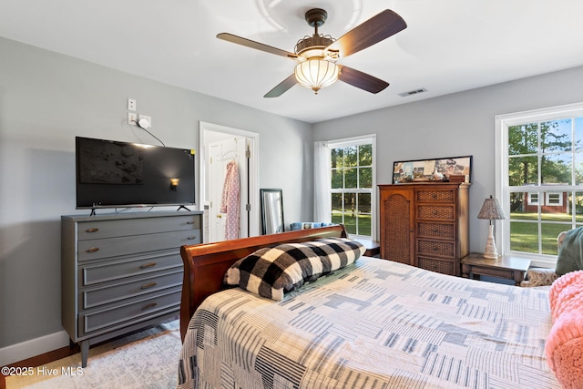 bedroom with visible vents, baseboards, and a ceiling fan