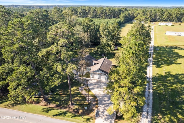 birds eye view of property with a wooded view