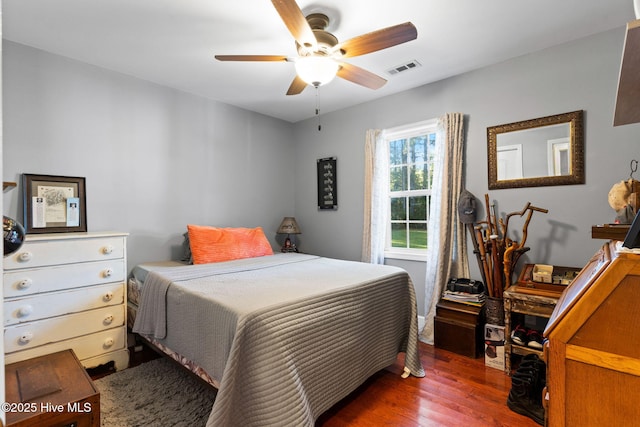 bedroom with visible vents, a ceiling fan, and wood finished floors