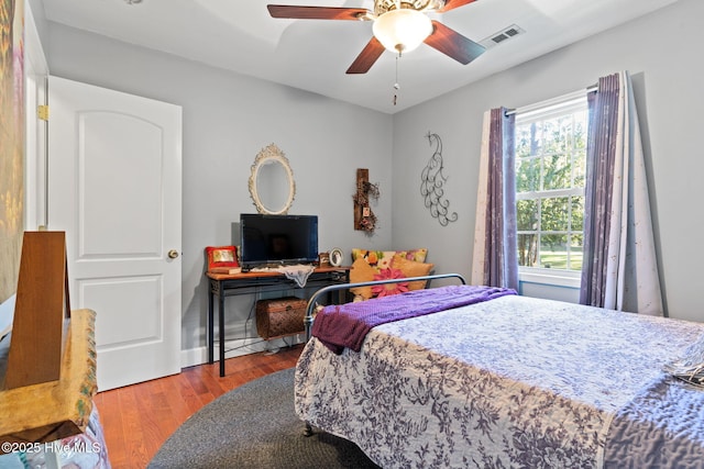 bedroom featuring visible vents, ceiling fan, and wood finished floors