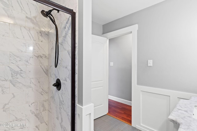 full bathroom featuring a shower stall and wood finished floors