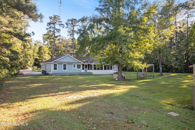 exterior space with a yard and a sunroom