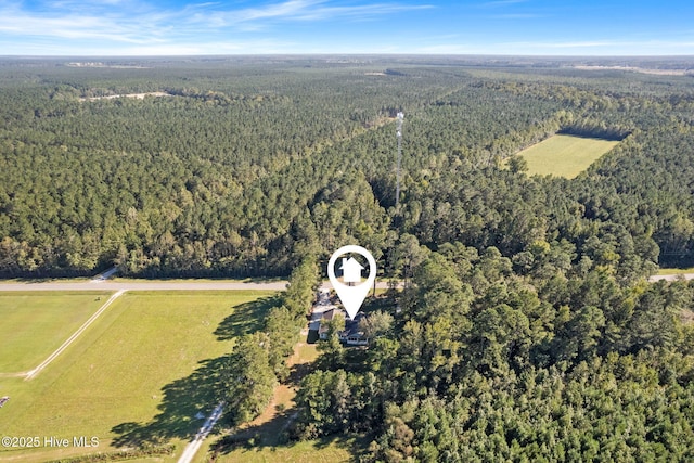 drone / aerial view with a wooded view