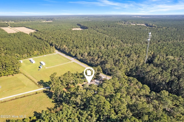 birds eye view of property with a wooded view