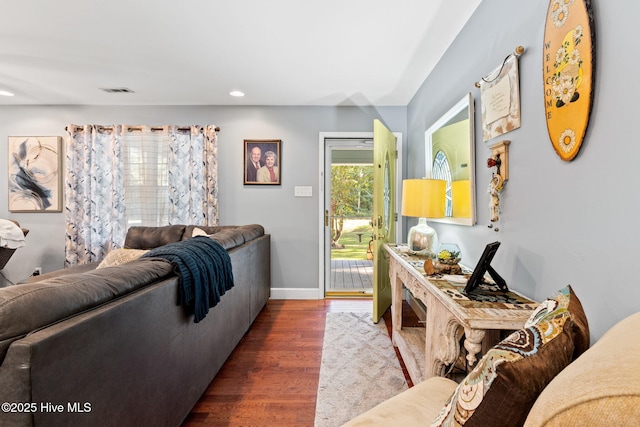 living area with recessed lighting, baseboards, and wood finished floors