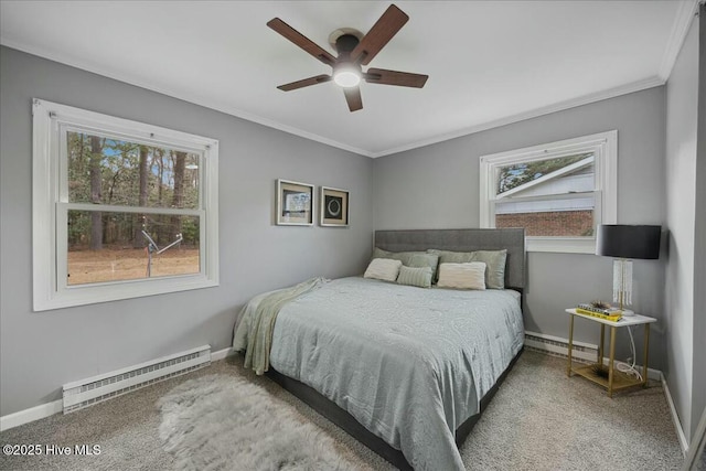 bedroom featuring a baseboard radiator, multiple windows, and baseboards