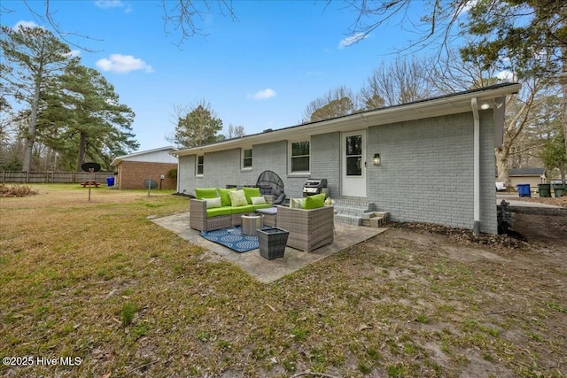 back of property featuring a lawn, fence, a patio area, an outdoor living space, and brick siding