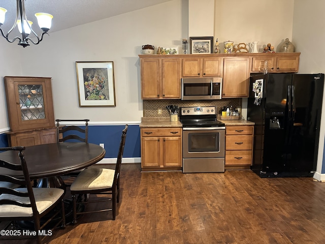 kitchen with lofted ceiling, brown cabinetry, stainless steel appliances, and dark wood-type flooring