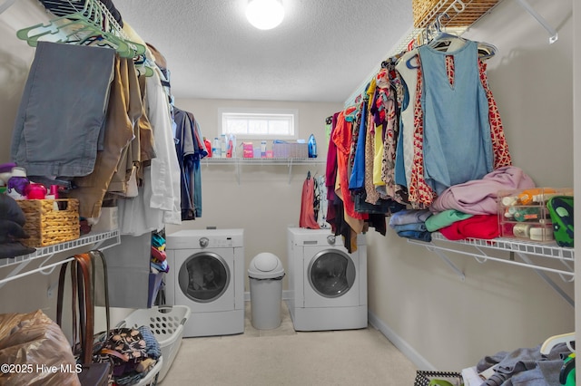 laundry area featuring a textured ceiling, laundry area, and separate washer and dryer