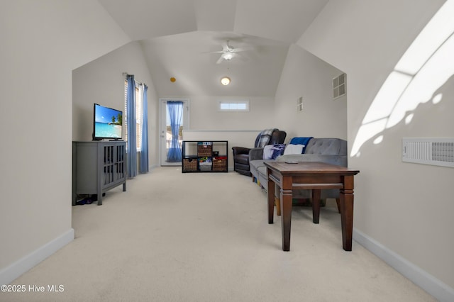 carpeted home office featuring lofted ceiling, baseboards, visible vents, and a ceiling fan