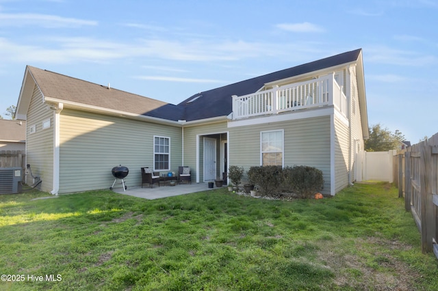 rear view of property featuring a patio area, a lawn, a fenced backyard, and central air condition unit