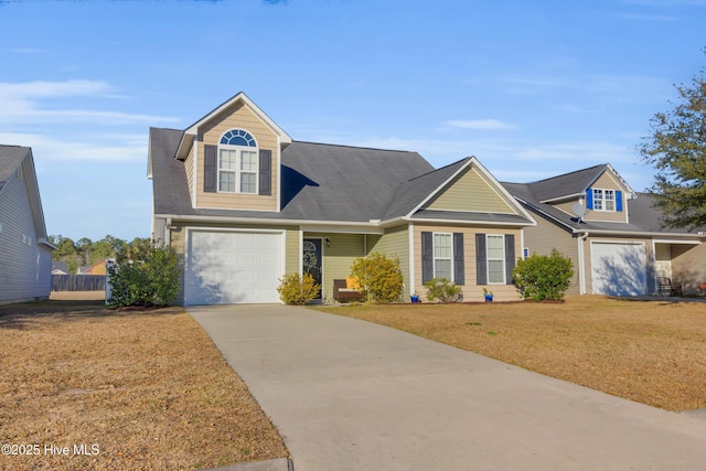 view of front of home with fence, a front lawn, and concrete driveway