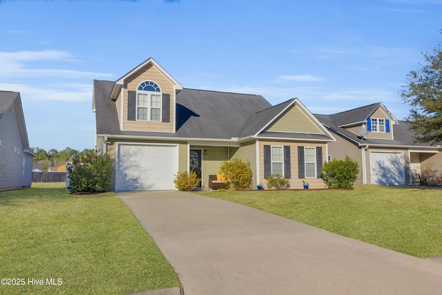 view of front of house with concrete driveway, a front lawn, and fence