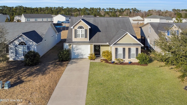 view of front facade featuring driveway, a front yard, and a residential view