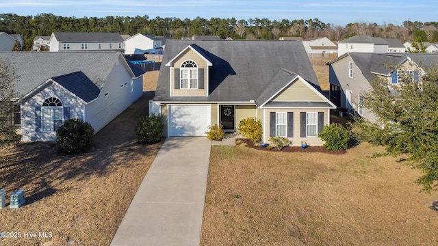 view of front facade with a residential view, driveway, and a front yard