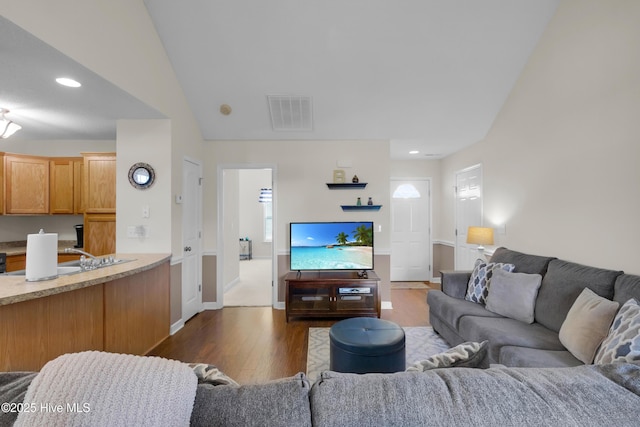 living area featuring baseboards, dark wood finished floors, visible vents, and recessed lighting