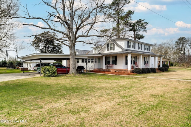 view of front facade with driveway, covered porch, a front lawn, and a carport