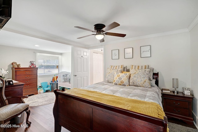 bedroom with ceiling fan, a closet, wood finished floors, and crown molding