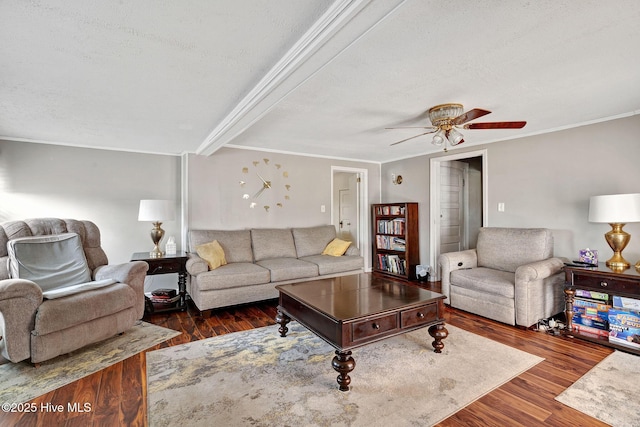 living room featuring a ceiling fan, crown molding, a textured ceiling, and wood finished floors