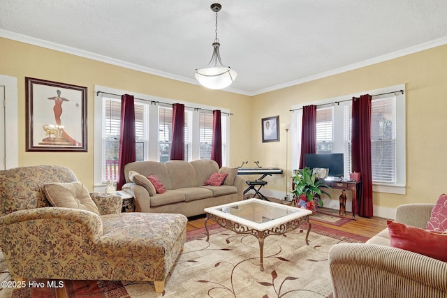 living area featuring a healthy amount of sunlight, crown molding, and wood finished floors