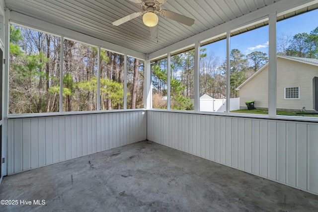 unfurnished sunroom with plenty of natural light and ceiling fan