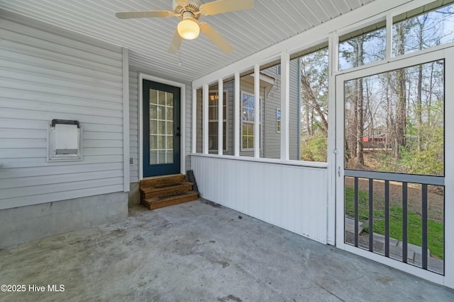 unfurnished sunroom featuring ceiling fan and a healthy amount of sunlight