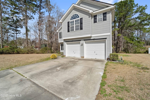 view of side of home with a garage, concrete driveway, and a yard