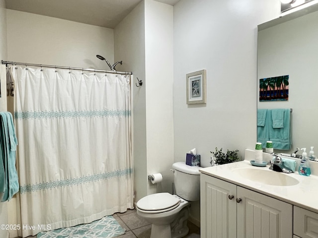 bathroom with toilet, vanity, a shower with shower curtain, and tile patterned floors