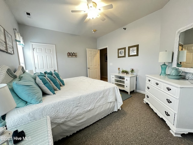 bedroom with ceiling fan, dark carpet, and baseboards