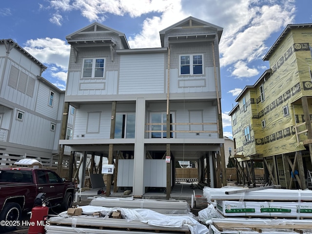 view of front facade with board and batten siding and a carport