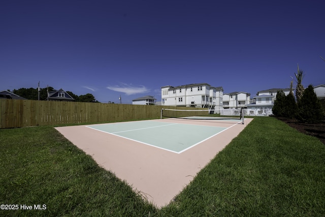 207 Spartanburg Ave Unit 1, Carolina Beach, NC 28428 - view of tennis court with fence, a yard, and a residential view