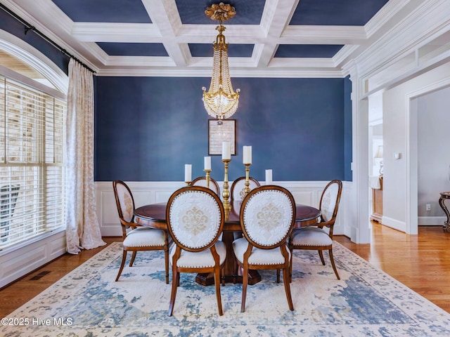 dining room featuring visible vents, beam ceiling, wood finished floors, crown molding, and a chandelier