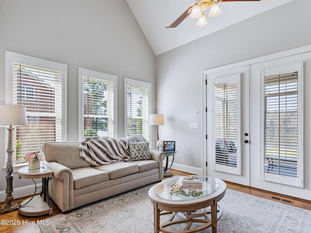 living area with visible vents, baseboards, ceiling fan, french doors, and wood finished floors