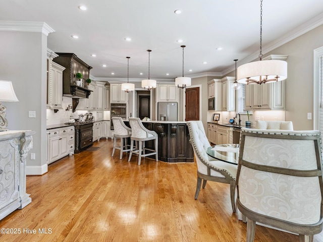 kitchen featuring stainless steel appliances, a kitchen breakfast bar, a center island, and crown molding