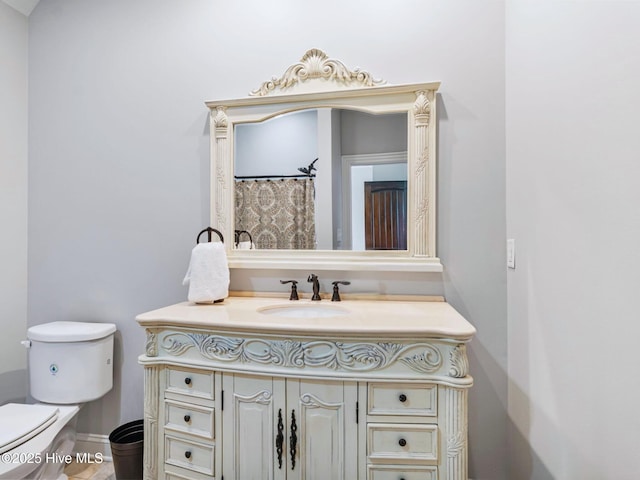 full bathroom featuring vanity and toilet