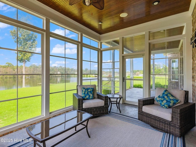 sunroom with wood ceiling, a water view, and ceiling fan