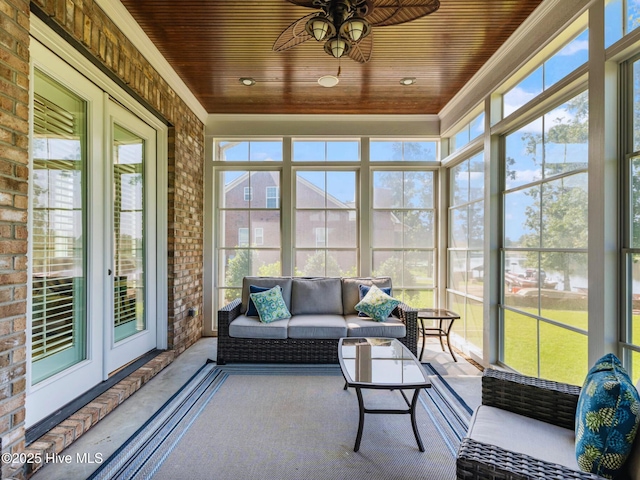 sunroom with a ceiling fan, wood ceiling, and a wealth of natural light