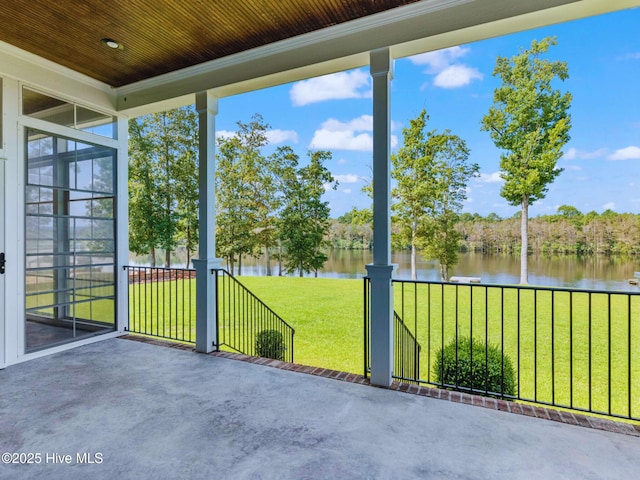 unfurnished sunroom featuring a water view