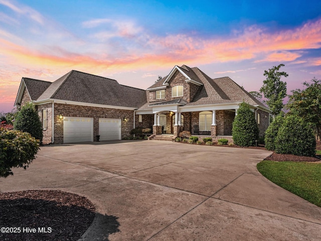 view of front of home featuring an attached garage, brick siding, driveway, and a shingled roof