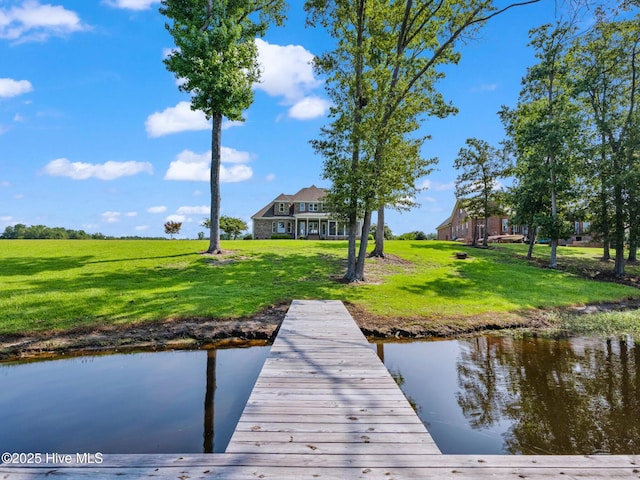 dock area with a yard and a water view