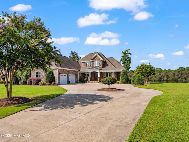 view of front of property featuring driveway, an attached garage, and a front yard